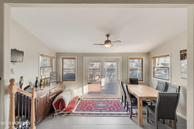 tiled dining room with vaulted ceiling and ceiling fan