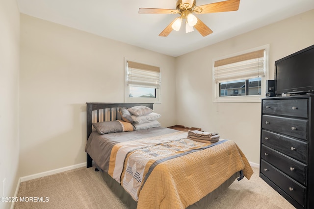 bedroom featuring ceiling fan and light carpet