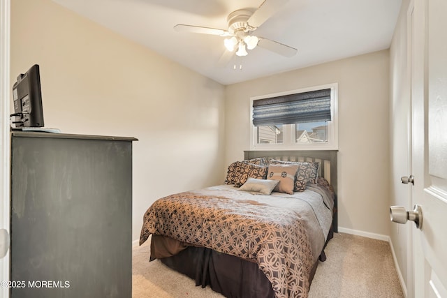 bedroom featuring light carpet and ceiling fan