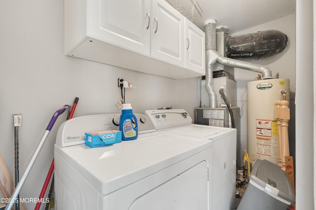 laundry area with cabinets, water heater, and washer and dryer