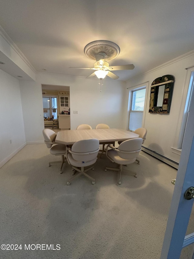 dining room with crown molding, a baseboard radiator, and ceiling fan