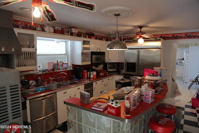 kitchen featuring white cabinetry, sink, custom range hood, and appliances with stainless steel finishes