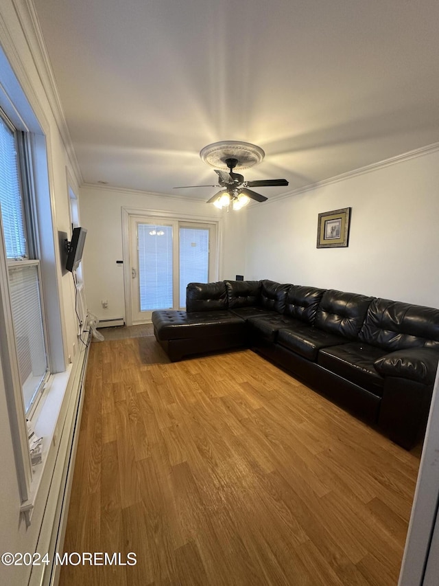 unfurnished living room featuring hardwood / wood-style flooring, crown molding, a baseboard heating unit, and ceiling fan