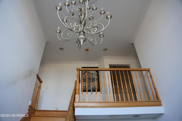 stairs with crown molding and a chandelier