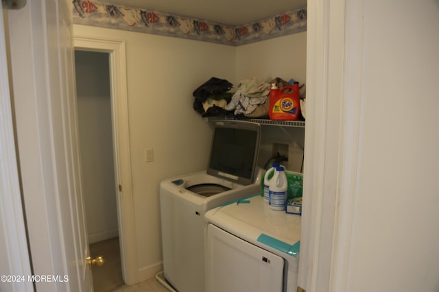 clothes washing area with washer and clothes dryer