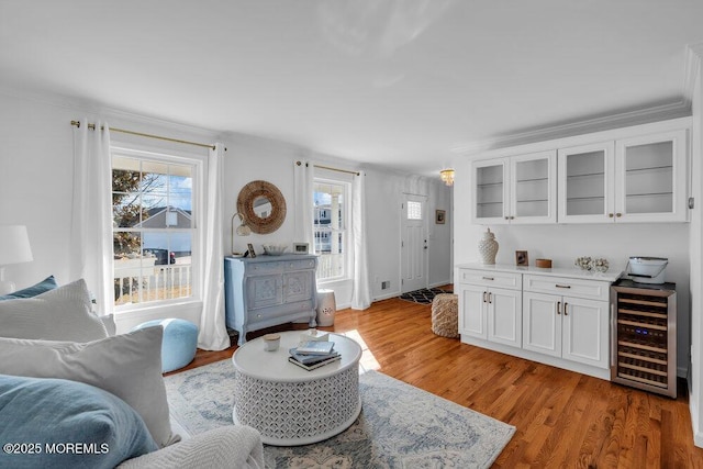 living room featuring wine cooler and light hardwood / wood-style flooring