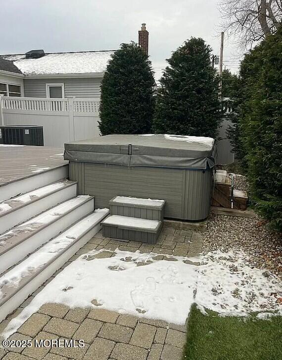 exterior space featuring a hot tub