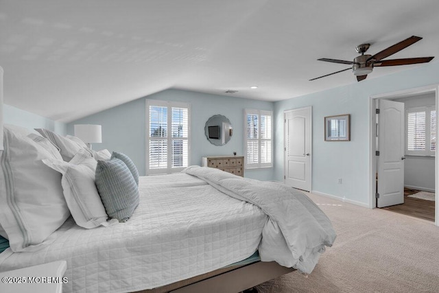 carpeted bedroom with vaulted ceiling and ceiling fan