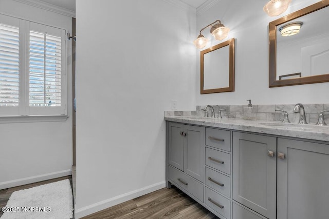 bathroom with ornamental molding, hardwood / wood-style floors, and vanity