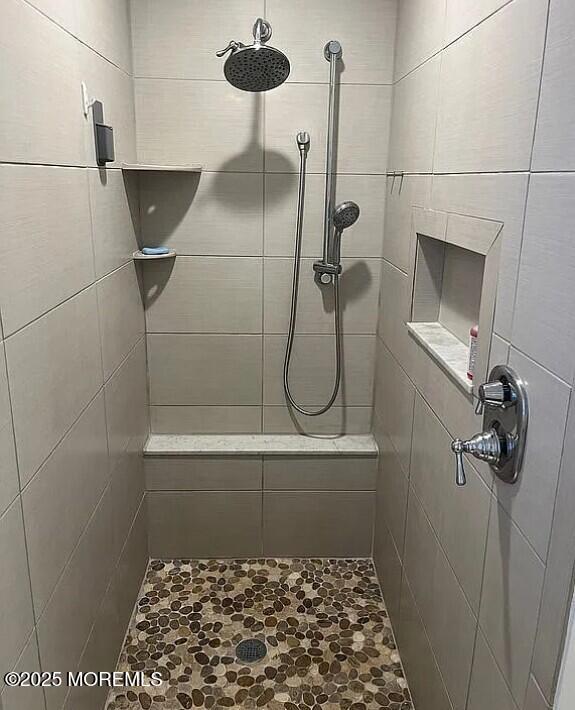 bathroom with tiled shower