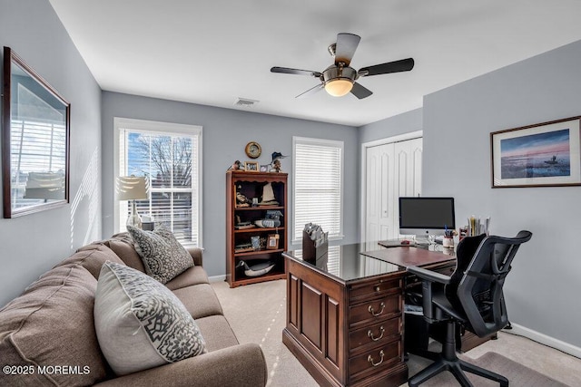 home office featuring ceiling fan and light carpet