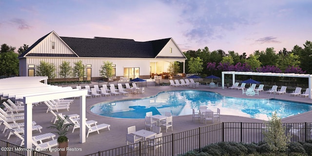 pool at dusk featuring a pergola and a patio area