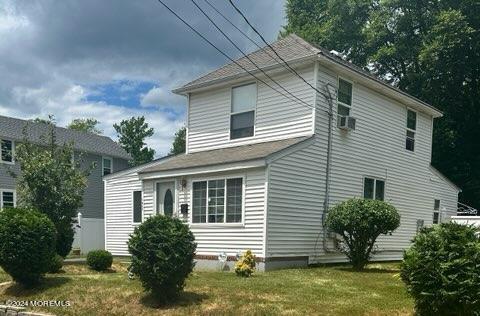 view of side of home with a yard