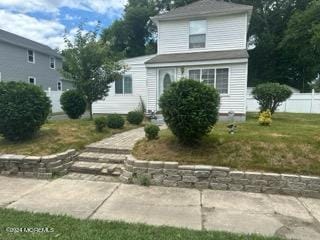 front facade with a front yard