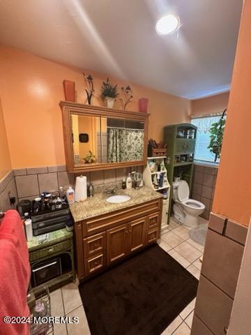 bathroom featuring tile patterned flooring, vanity, and toilet