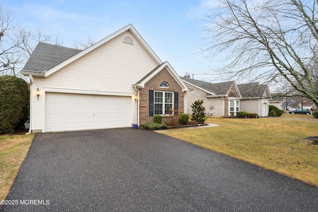 view of front of home featuring a garage and a front lawn