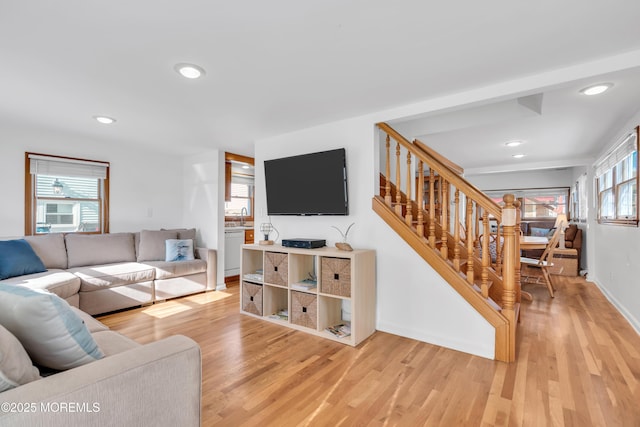 living room with sink and light hardwood / wood-style flooring