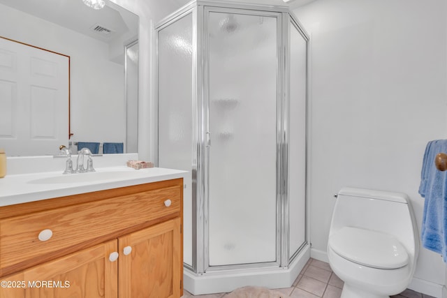 bathroom with an enclosed shower, vanity, tile patterned floors, and toilet