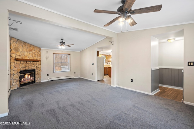 unfurnished living room with crown molding, a baseboard heating unit, carpet, a fireplace, and vaulted ceiling