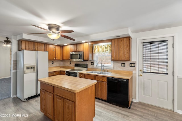 kitchen featuring sink, electric range oven, dishwasher, a kitchen island, and white refrigerator with ice dispenser