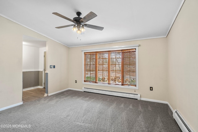 carpeted spare room featuring ornamental molding, a baseboard heating unit, and ceiling fan