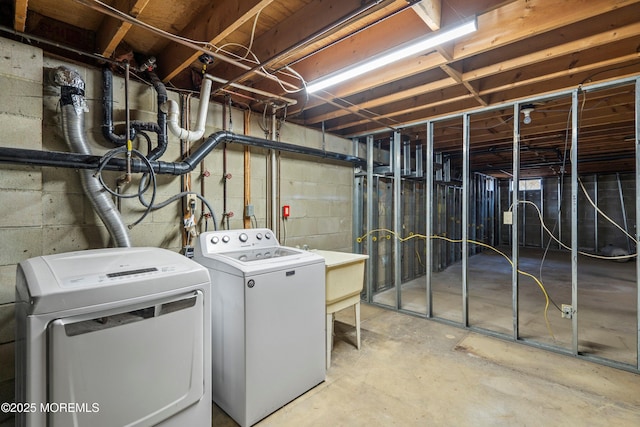 clothes washing area with washing machine and dryer