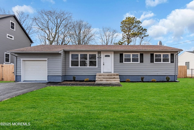 ranch-style home with a garage and a front lawn