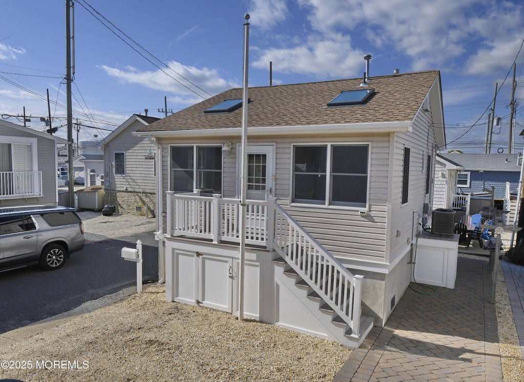 back of house featuring central air condition unit