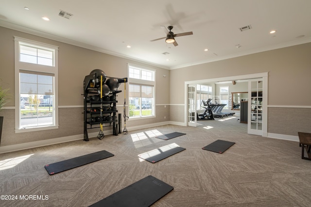 workout room with light carpet, crown molding, french doors, and ceiling fan