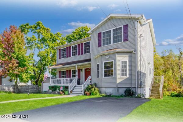 view of front of home with a front lawn and covered porch