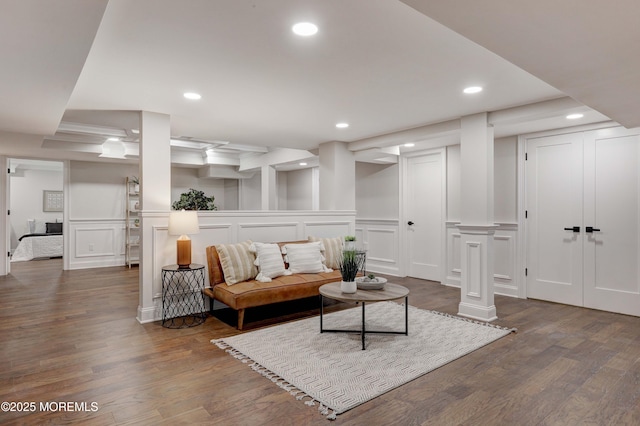 living room featuring dark wood-style floors, recessed lighting, and a decorative wall