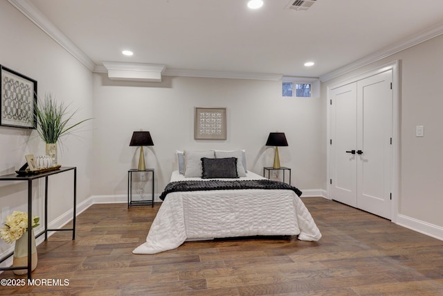 bedroom with baseboards, ornamental molding, dark wood-type flooring, and recessed lighting