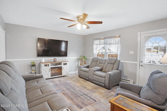 living room with a baseboard heating unit and ceiling fan