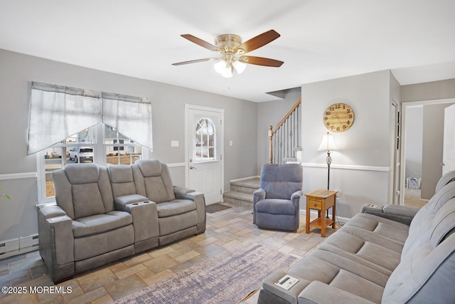 living room featuring a baseboard heating unit and ceiling fan