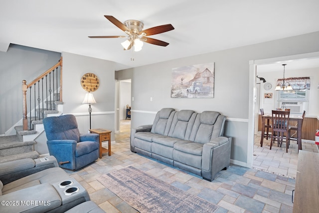 living room with ceiling fan with notable chandelier and cooling unit