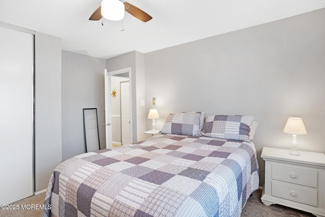 carpeted bedroom featuring ceiling fan and a closet