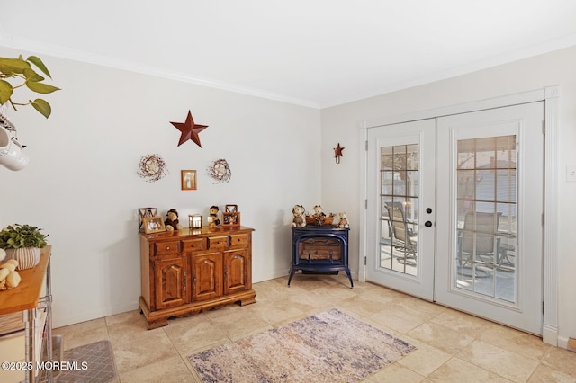 doorway with crown molding, a wood stove, and french doors