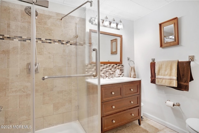 bathroom with tasteful backsplash, vanity, toilet, and walk in shower