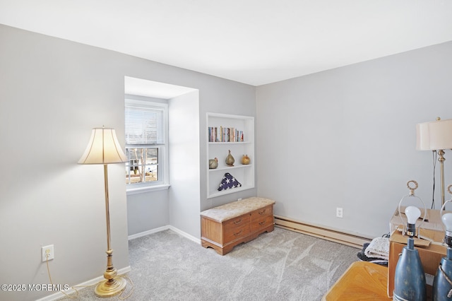 living area with light colored carpet and baseboard heating