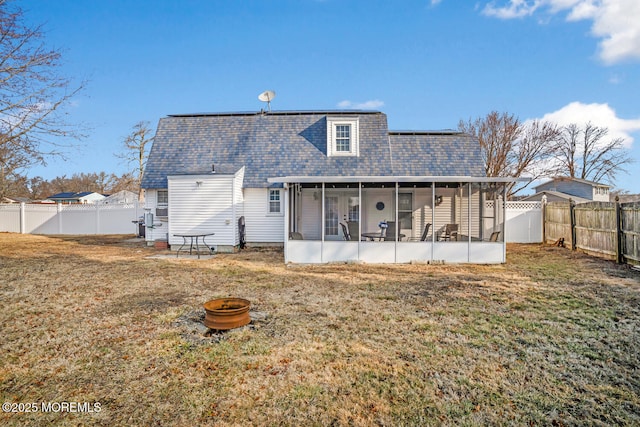 back of house with a yard and a sunroom