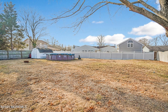 view of yard featuring a storage unit and a covered pool