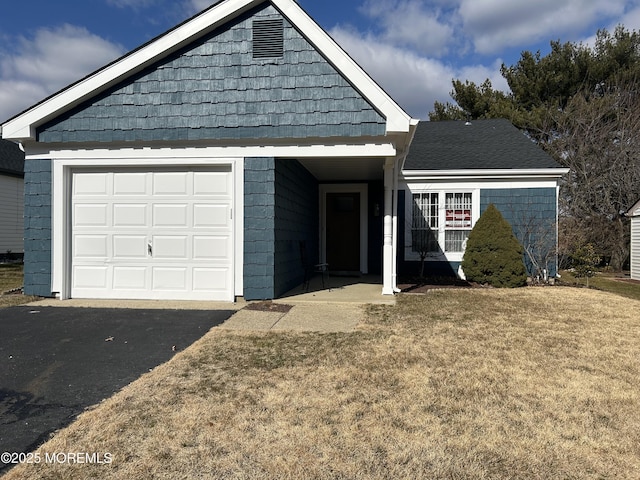 view of front of home with a garage and a front yard