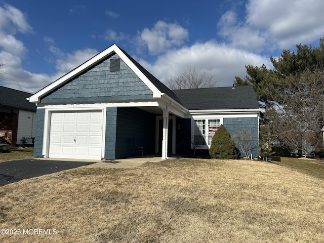 view of front of house with a garage and a front lawn