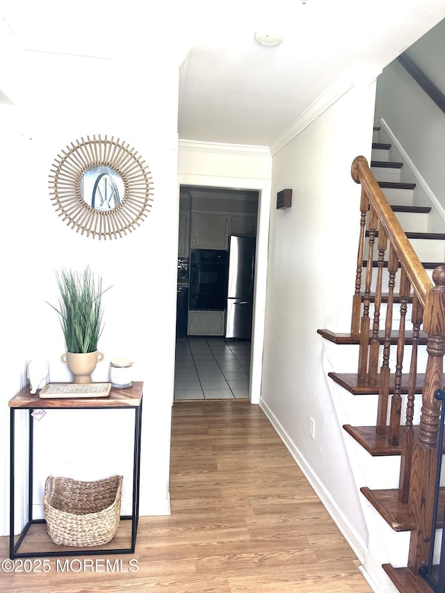 hall featuring crown molding and light wood-type flooring