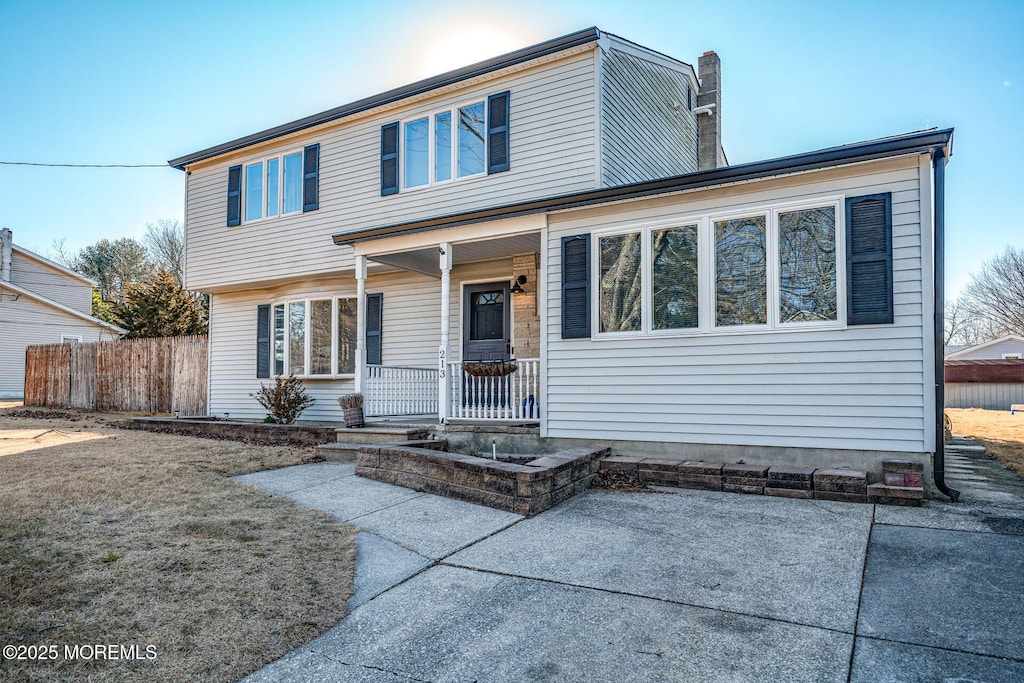 view of front of home featuring covered porch and a patio