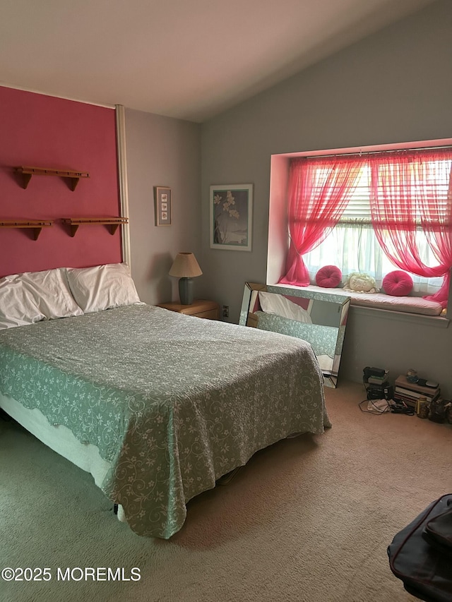 carpeted bedroom with lofted ceiling