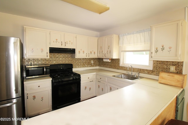 kitchen with white cabinetry, appliances with stainless steel finishes, sink, and tasteful backsplash