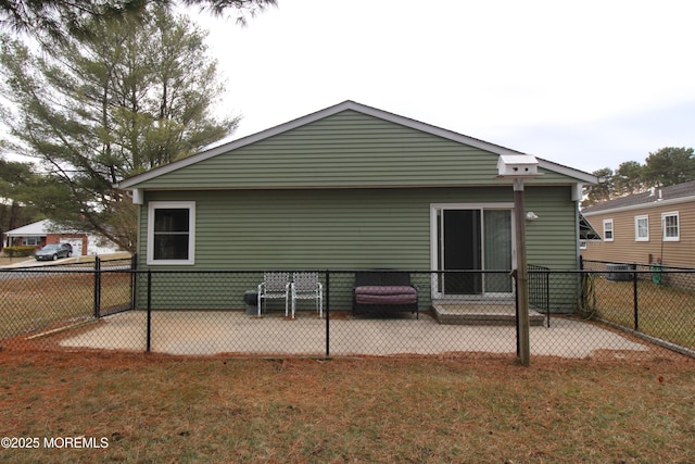 back of property featuring a lawn and a patio area