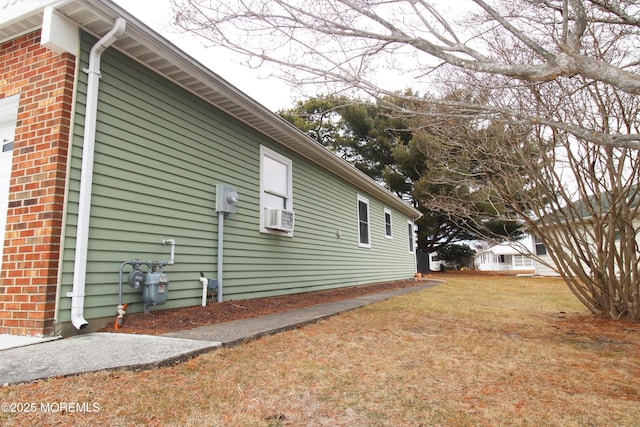 view of property exterior with cooling unit and a yard