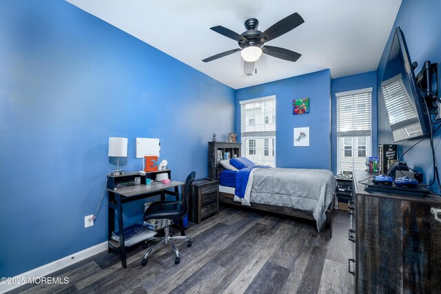 bedroom with ceiling fan and dark hardwood / wood-style floors